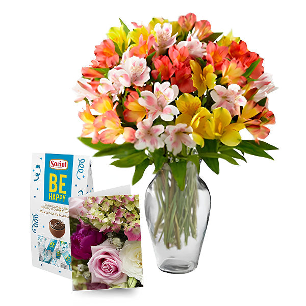 alstroemerias in a vase with chocolates and a greeting card