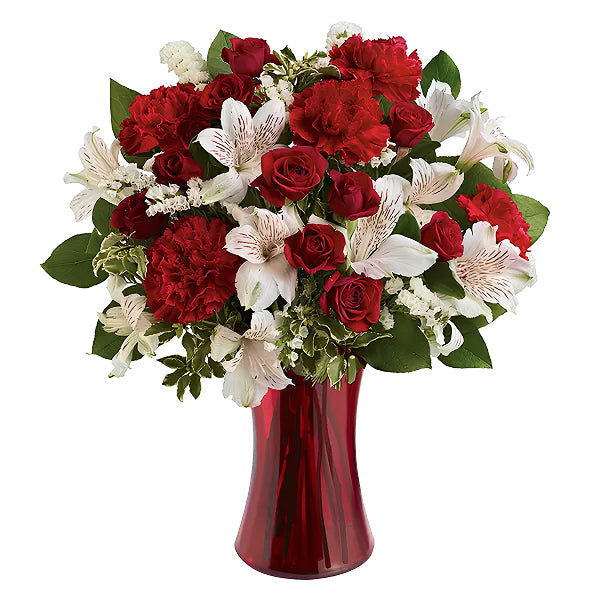 red and white flowers in a red vase